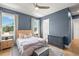 Serene blue bedroom with a wooden bed frame, matching nightstands, and a view into an ensuite bathroom at 4114 W Neptune St, Tampa, FL 33629