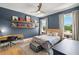 Stylish bedroom with blue walls, a wooden bed frame, floating shelves, and warm lighting at 4114 W Neptune St, Tampa, FL 33629
