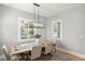 Chic dining room featuring a wooden table with seating for four beneath a modern light fixture at 4114 W Neptune St, Tampa, FL 33629