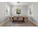 This light-filled dining room features a wooden table with seating for four and views of the landscaped yard at 4114 W Neptune St, Tampa, FL 33629