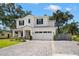 Inviting two-story home with brick paver driveway, lush green lawn, and a charming basketball hoop at 4114 W Neptune St, Tampa, FL 33629