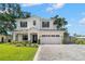 Beautifully landscaped two-story home with brick driveway, a three-car garage, and impeccable curb appeal at 4114 W Neptune St, Tampa, FL 33629