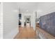 Bright hallway with hardwood floors and white shiplap walls leads to other rooms at 4114 W Neptune St, Tampa, FL 33629