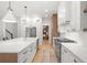 Modern kitchen featuring a large island, stainless steel appliances, and hardwood floors at 4114 W Neptune St, Tampa, FL 33629