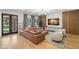 Beautiful living room with modern furniture, wood paneling, and a view of the pool at 4114 W Neptune St, Tampa, FL 33629