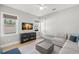 Bright living room features neutral decor, plush seating, and a ceiling fan at 4114 W Neptune St, Tampa, FL 33629