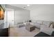 Living room showcases neutral decor, plush sectional sofa, and wood flooring at 4114 W Neptune St, Tampa, FL 33629