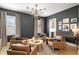 Cozy living room with warm leather chairs, modern lighting, and wet bar at 4114 W Neptune St, Tampa, FL 33629