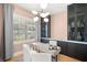 Chic office featuring a modern chandelier, sleek built-ins, and light pink walls at 4114 W Neptune St, Tampa, FL 33629