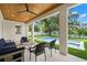 Inviting covered patio featuring comfortable seating with view of backyard pool at 4114 W Neptune St, Tampa, FL 33629