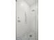 Glass enclosed shower featuring contemporary fixtures and mosaic tile flooring at 4114 W Neptune St, Tampa, FL 33629