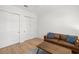 Inviting sitting room with a leather couch and multiple doors for privacy or easy access at 4114 W Neptune St, Tampa, FL 33629