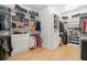 Spacious walk-in closet with custom shelving, drawers, and ample hanging space for organized storage solutions at 4114 W Neptune St, Tampa, FL 33629