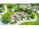 Aerial view of the condo community highlighting rooftops, manicured lawns, mature trees, and community pool at 498 Lakeview Dr # 45, Palm Harbor, FL 34683
