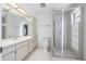 Bright bathroom with glass enclosed shower and large vanity with a sink at 498 Lakeview Dr # 45, Palm Harbor, FL 34683