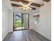 Bright dining area with wood beam ceiling, fan, and sliding glass doors to the outside at 498 Lakeview Dr # 45, Palm Harbor, FL 34683