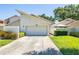 Inviting exterior showcasing a well-maintained facade, garage, and landscaped front yard of home number 45 at 498 Lakeview Dr # 45, Palm Harbor, FL 34683