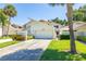 Inviting exterior showcasing a well-maintained facade, garage, and landscaped front yard of home number 45 at 498 Lakeview Dr # 45, Palm Harbor, FL 34683