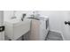 Laundry room with white washer, dryer, utility sink, gray flooring, and white walls at 498 Lakeview Dr # 45, Palm Harbor, FL 34683