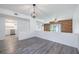 Open-concept living room with hardwood floors, a unique wood accent wall, and abundant natural light at 498 Lakeview Dr # 45, Palm Harbor, FL 34683