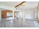Bright living room with wood accent wall, mirrored closet and fan at 498 Lakeview Dr # 45, Palm Harbor, FL 34683