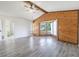 Spacious living room features a wood paneled accent wall with a bay window at 498 Lakeview Dr # 45, Palm Harbor, FL 34683