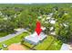 This aerial view shows a well maintained home and yard surrounded by mature trees in a quiet neighborhood at 505 Broxburn Ave, Temple Terrace, FL 33617