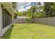 Grassy backyard with a wooden fence at 505 Broxburn Ave, Temple Terrace, FL 33617