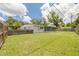 Large backyard with a green lawn and a wooden fence, perfect for outdoor activities at 505 Broxburn Ave, Temple Terrace, FL 33617