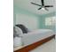 Comfortable bedroom with a ceiling fan, a light-filled window, and a double door closet at 505 Broxburn Ave, Temple Terrace, FL 33617