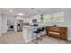 Bright kitchen features white cabinets, stainless steel appliances, and granite countertops with barstool seating at 505 Broxburn Ave, Temple Terrace, FL 33617