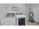 Modern laundry room with a washer and dryer, and a water heater at 505 Broxburn Ave, Temple Terrace, FL 33617
