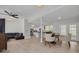 Open-concept living space with new floors, fan, and access to kitchen and rear of home at 505 Broxburn Ave, Temple Terrace, FL 33617