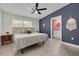 Stylish main bedroom with a ceiling fan, ensuite bath access, and plenty of natural light at 505 Broxburn Ave, Temple Terrace, FL 33617