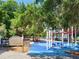 A colorful playground with multiple play structures in Riverhills Park at 505 Broxburn Ave, Temple Terrace, FL 33617