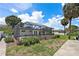 A partial view of the screened-in pool area and minimal grass visible in this backyard at 5285 Dover Ne St, St Petersburg, FL 33703