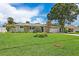 Inviting single-story home with a well-manicured lawn, stone accents, and attached two-car garage at 5285 Dover Ne St, St Petersburg, FL 33703