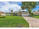 Charming single-story home with stone accents, lush lawn, and a brick driveway at 5285 Dover Ne St, St Petersburg, FL 33703