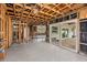 Living room with exposed studs, tile flooring, and glass doors that lead to a covered patio and backyard at 5285 Dover Ne St, St Petersburg, FL 33703