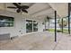 Covered patio featuring tile flooring, ceiling fans, and access to the backyard and waterfront, ready for outdoor living at 5285 Dover Ne St, St Petersburg, FL 33703