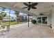 Large screened patio with tile flooring, ceiling fans, water views, and a grill area perfect for entertaining at 5285 Dover Ne St, St Petersburg, FL 33703