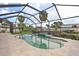 Inviting screened-in pool and deck area overlooking the tranquil waterfront and palm trees at 5285 Dover Ne St, St Petersburg, FL 33703