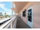 Outdoor balcony area with white railings, community views, and outdoor furniture at 6025 Shore S Blvd # 408, Gulfport, FL 33707
