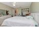 Neutral bedroom with white comforter, dresser, and closet view at 6025 Shore S Blvd # 408, Gulfport, FL 33707