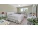 Comfortable bedroom with neutral tones, a white comforter, and a window with a neighborhood view at 6025 Shore S Blvd # 408, Gulfport, FL 33707