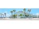 Exterior view of Gulfport Casino with palm trees, clear sky, and ample parking for visitors at 6025 Shore S Blvd # 408, Gulfport, FL 33707