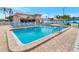 Large community pool with blue lounge chairs and a well-maintained deck under a sunny sky at 6025 Shore S Blvd # 408, Gulfport, FL 33707
