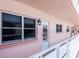 Hallway featuring a white railing and several windows, providing natural light and exterior views at 6025 Shore S Blvd # 408, Gulfport, FL 33707