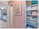 Hallway with linen closet and doorway leading to the bedroom and view of bed with white comforter at 6025 Shore S Blvd # 408, Gulfport, FL 33707