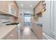 Well-lit kitchen featuring updated appliances and plenty of counter space at 6025 Shore S Blvd # 408, Gulfport, FL 33707